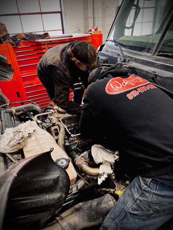 Wolf Specialized Drivetrain tech working on a semi-truck engine